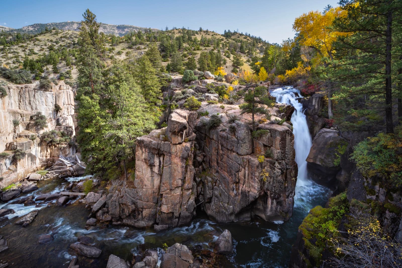 Shell Falls cascading through the Bighorn Mountain canyon in autumn