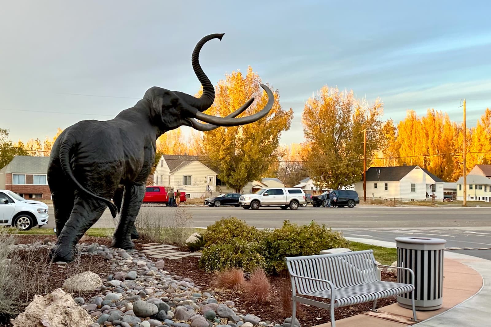 The Worland Mammoth statue framed by autumn cottonwoods on Big Horn Avenue in Washakie County, Wyoming